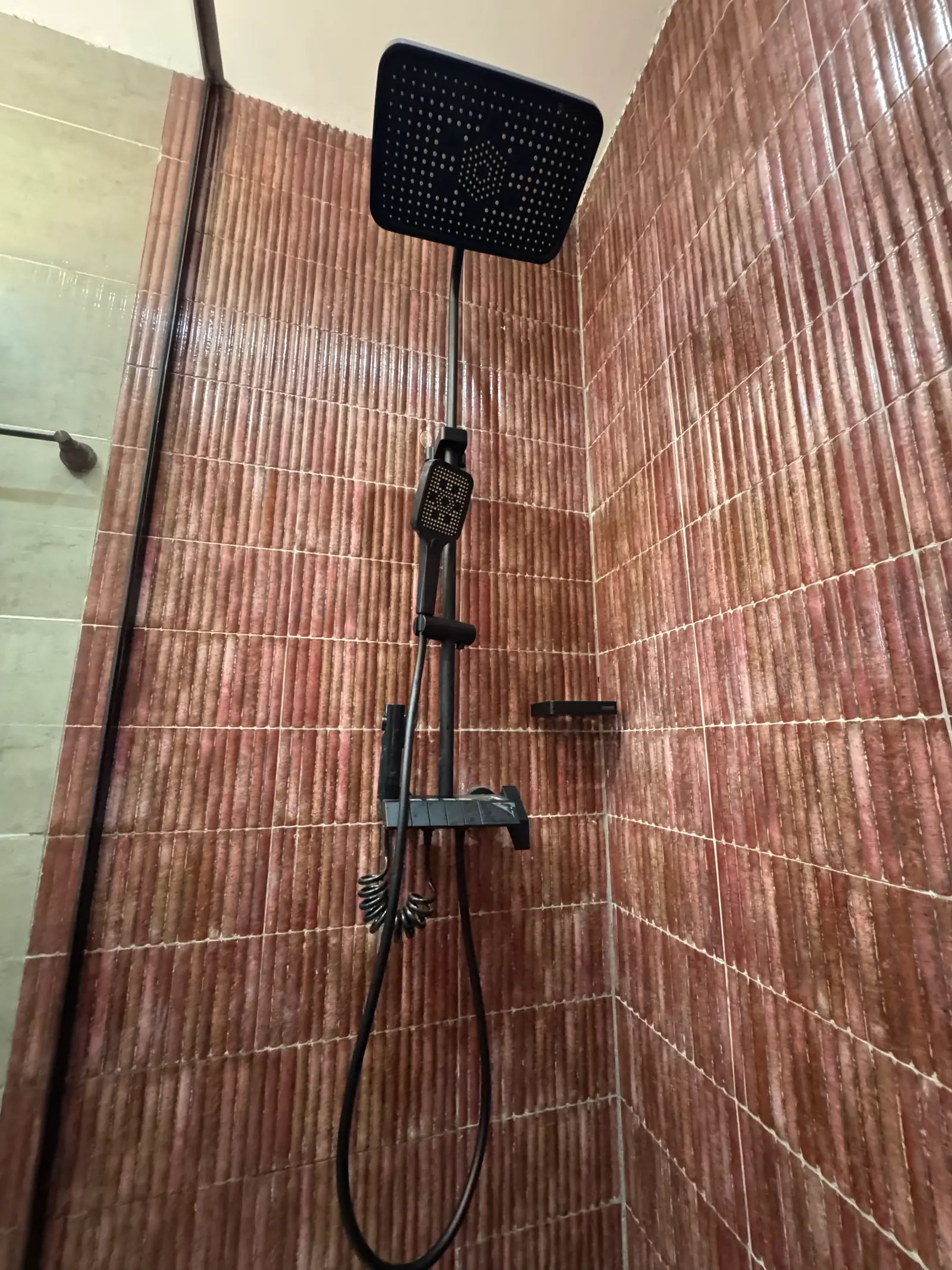 Rain shower against terracotta brick tiles